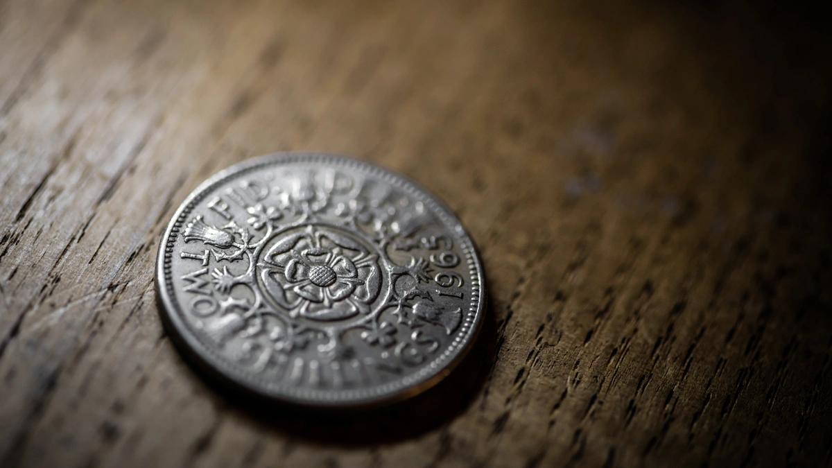 close up view of an ancient coin on a wooden table