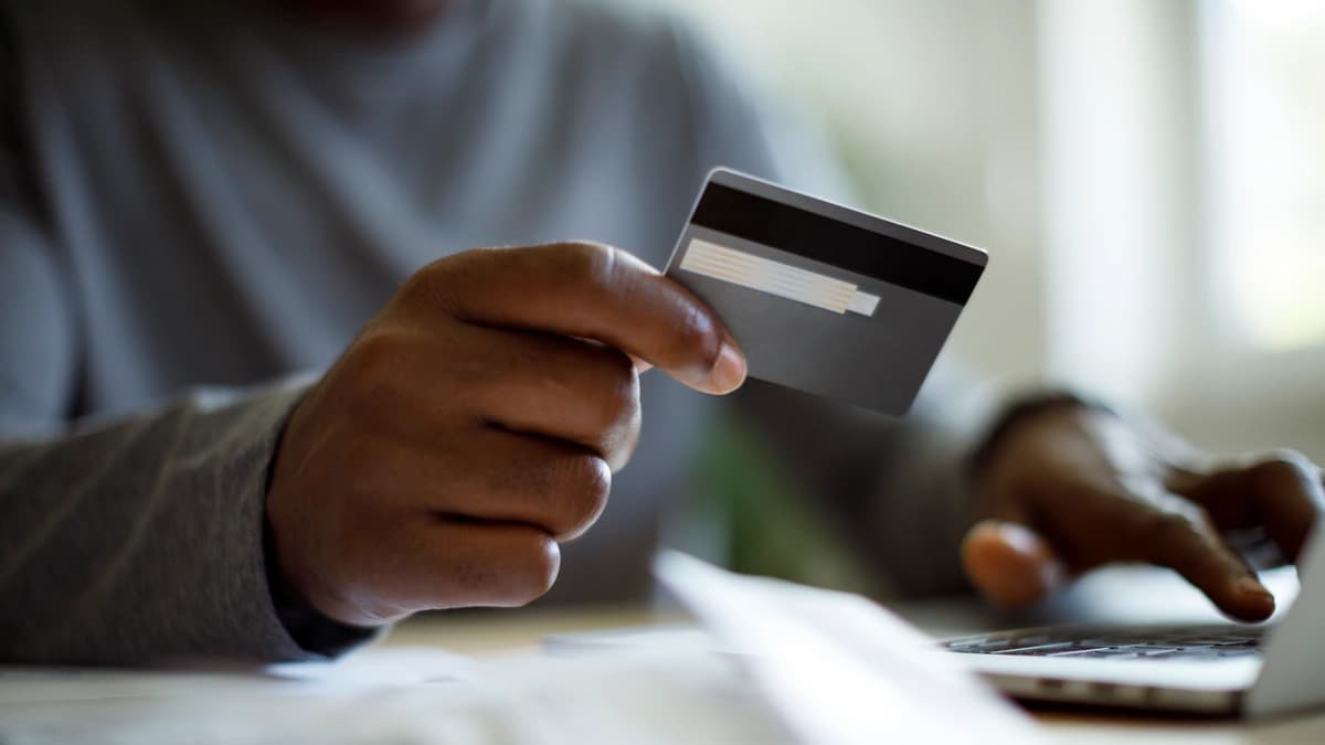 Man using a credit card to pay bills 