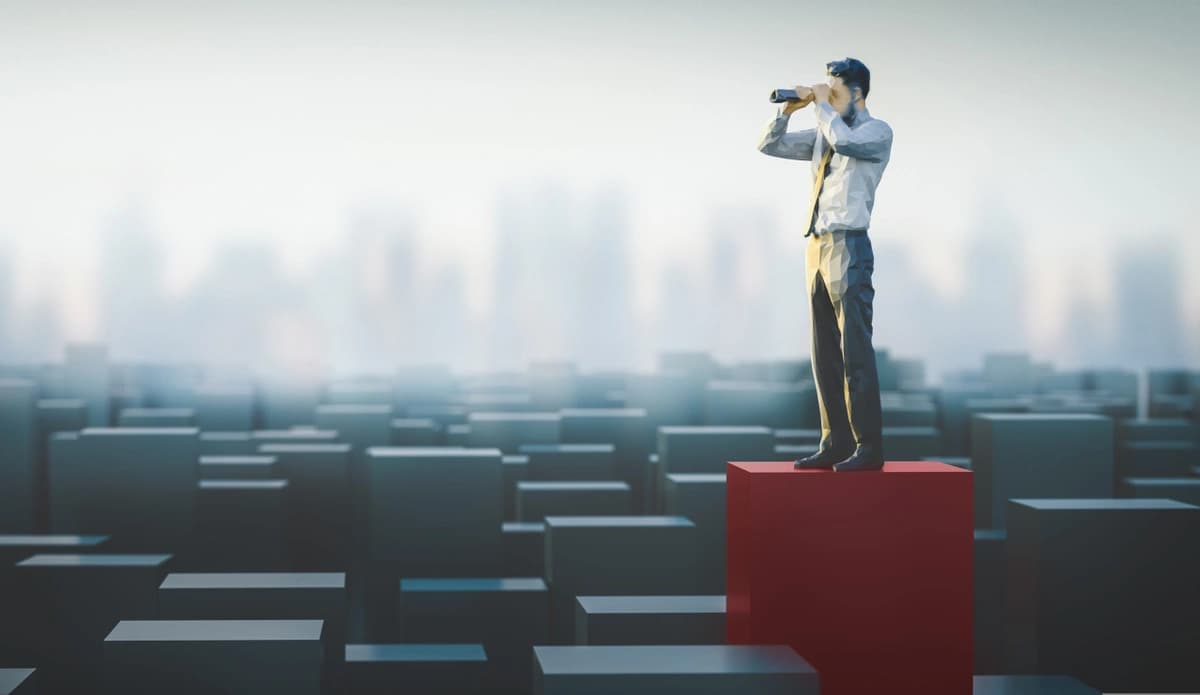 doll with binoculars standing on a red block