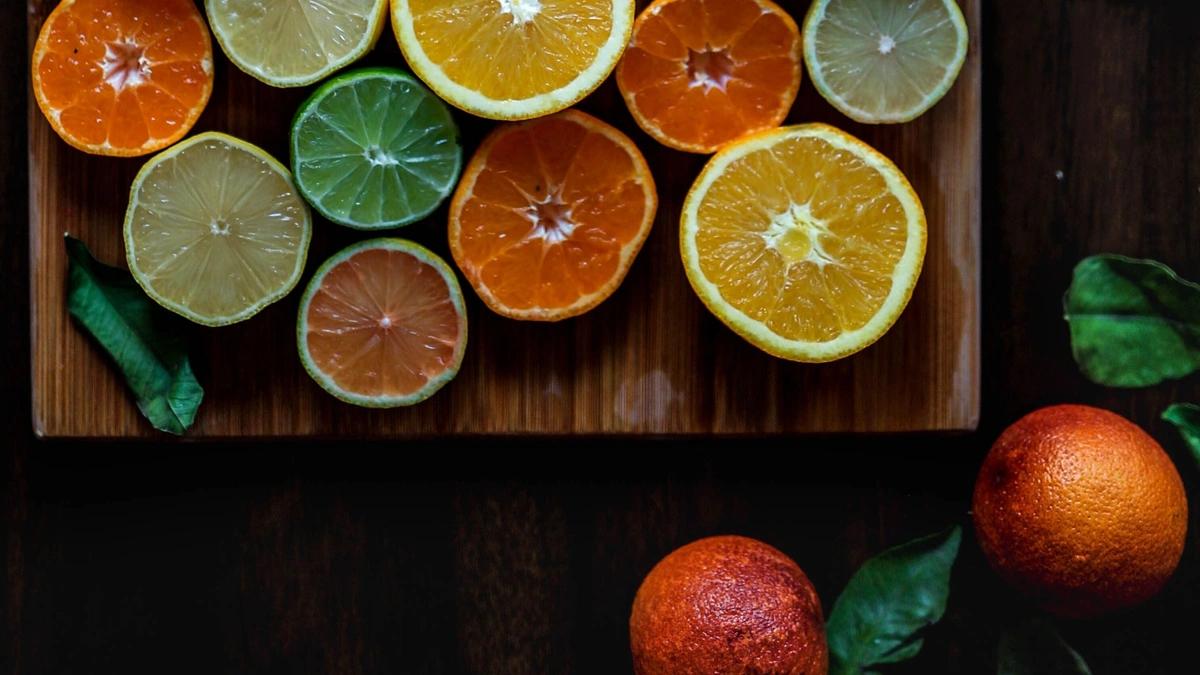 several citrus fruits sliced in half on tray